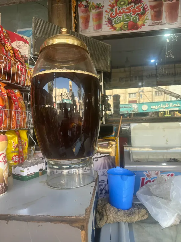 Sous — a large glass urn of liquorice root infusion at a street stall in Syria