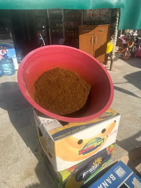 Tub of liquorice root mixture fermenting in the sun outside a shop