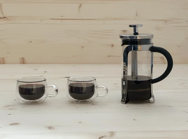 Two glass cups of brewed NooTea with French press showing re-infusion
