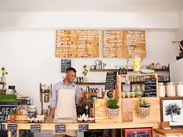 Professional café environment with barista serving specialty drinks